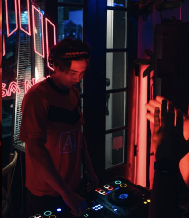 DJ playing a Casa Nova show surrounded by neon lights